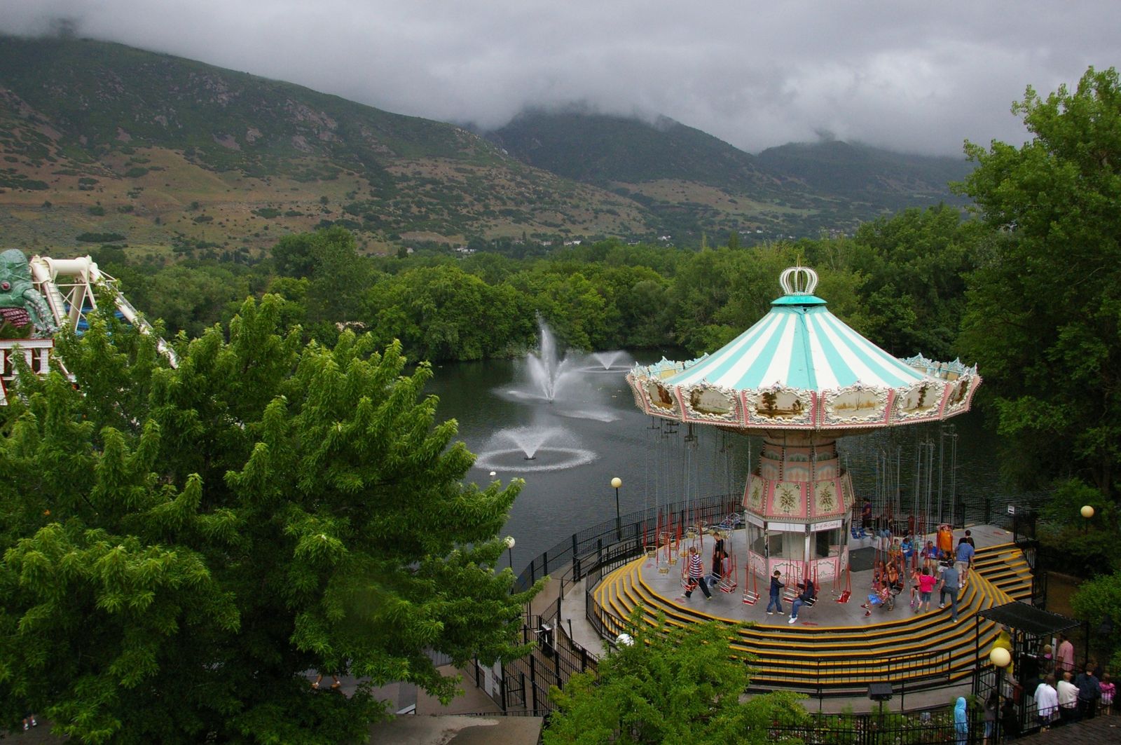 Lagoon Lake, fountains, and the swing carousel under storm clouds