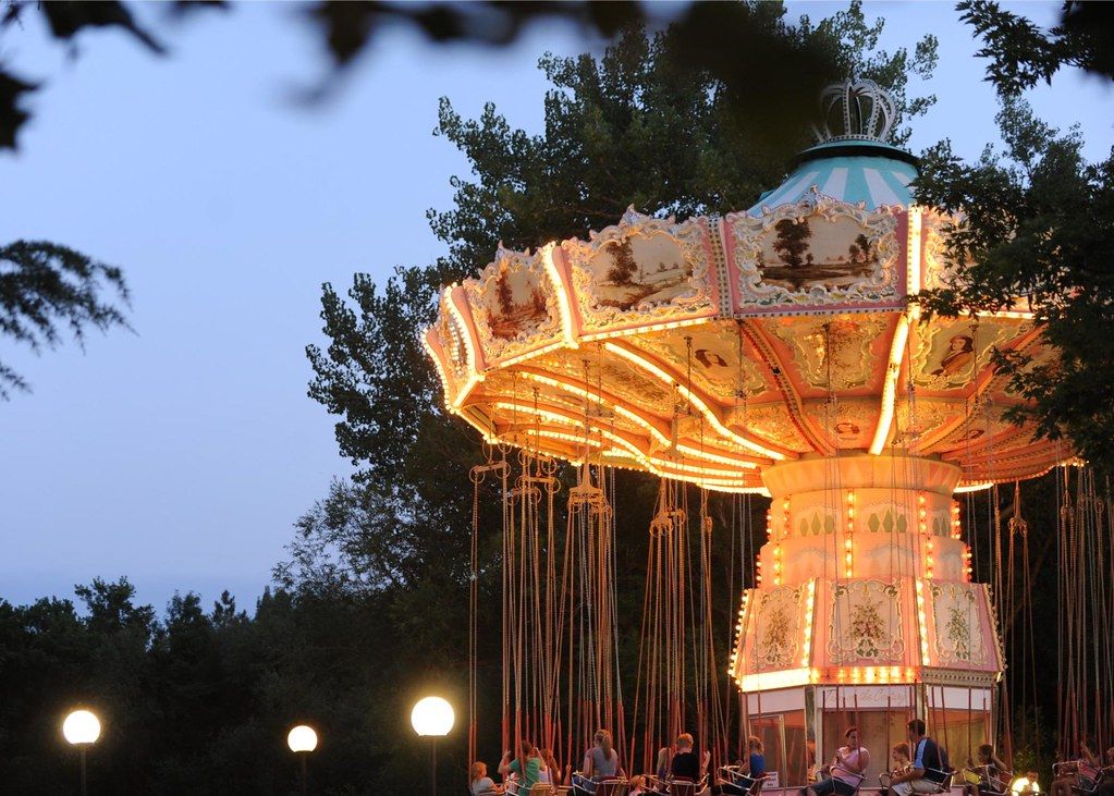 Turn of the Century swings lit at dusk